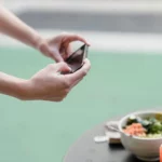 Influencer photographing a salad with a smartphone