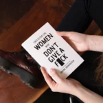 Woman Holding White Book