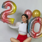 Girl holding 2 and 0 balloons