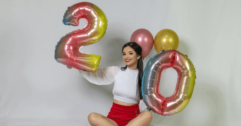 Girl holding 2 and 0 balloons